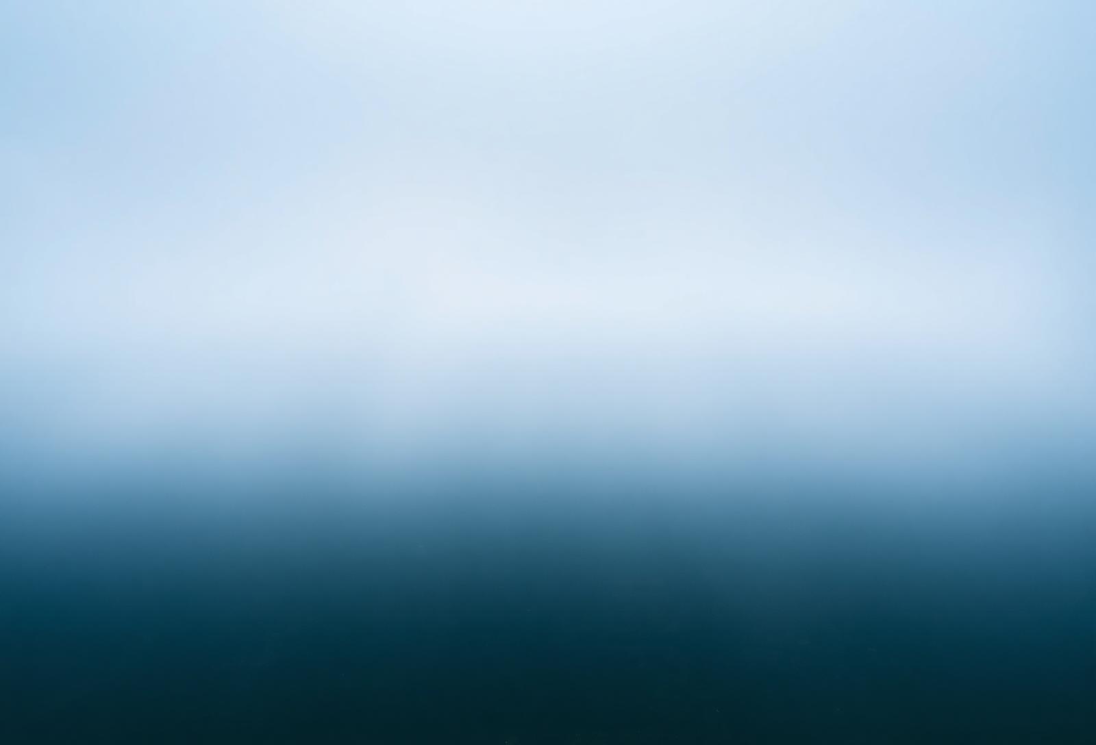 Mist rising over still water at dawn, evoking liminality and steadiness.